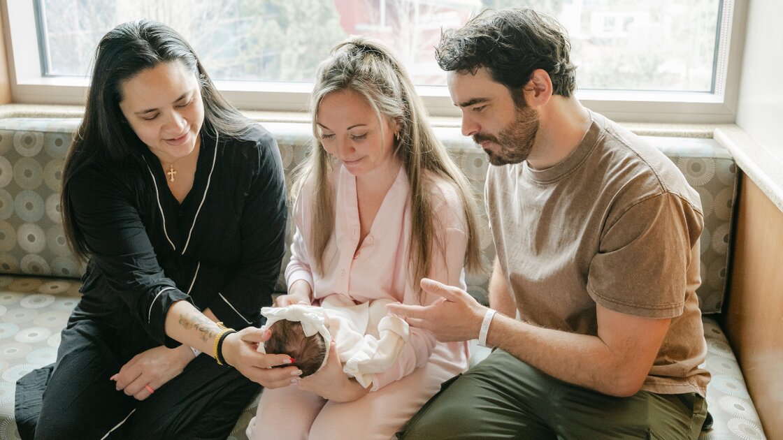 New family with baby celebrating surrogacy grant support