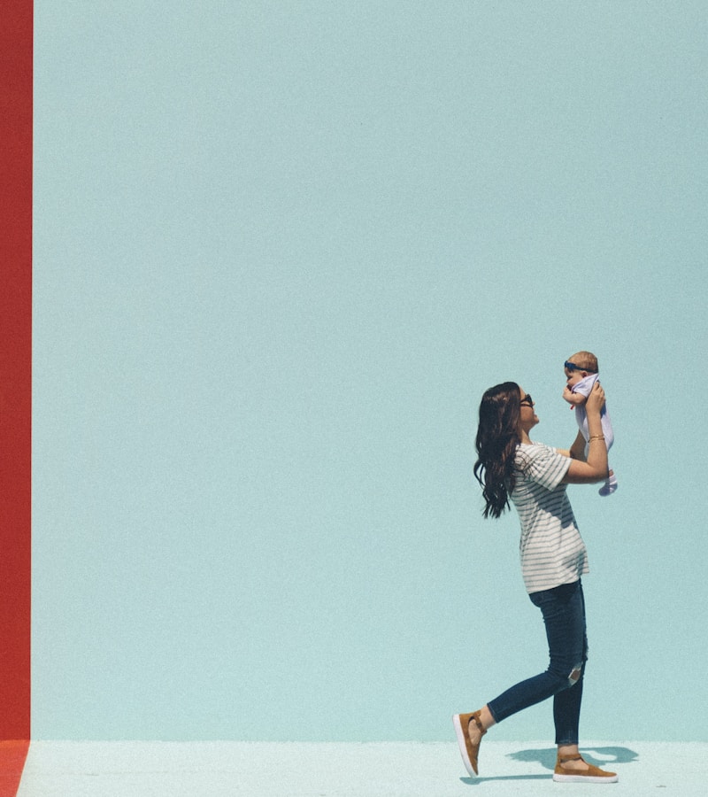 Happy mother lifting her baby